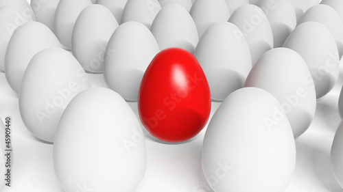Red Easter egg among white eggs