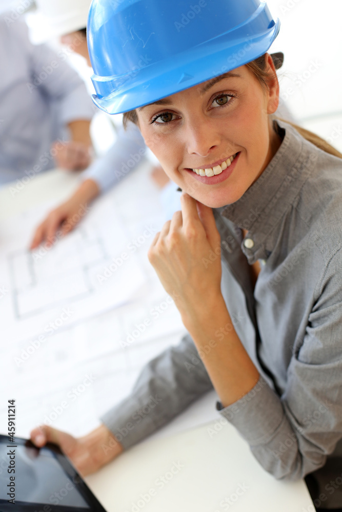 Architect with security helmet using electronic tablet Architect with security helmet using electronic tablet