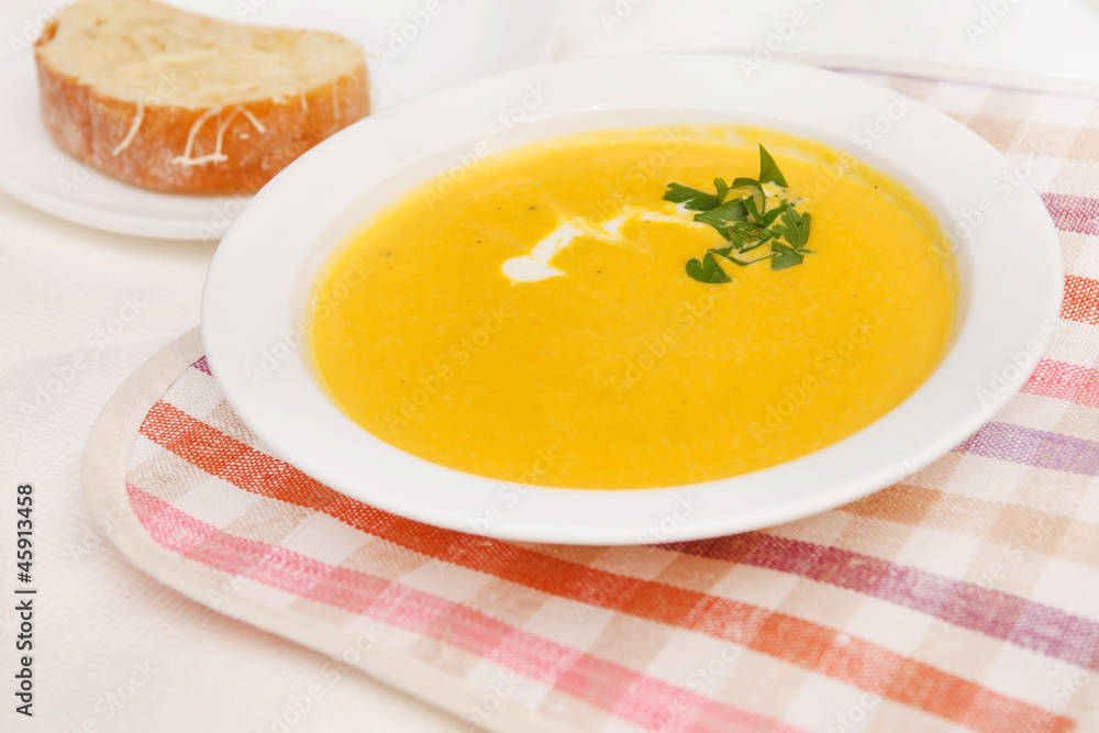 Pumpkin soup in white bowl Pumpkin soup in white bowl