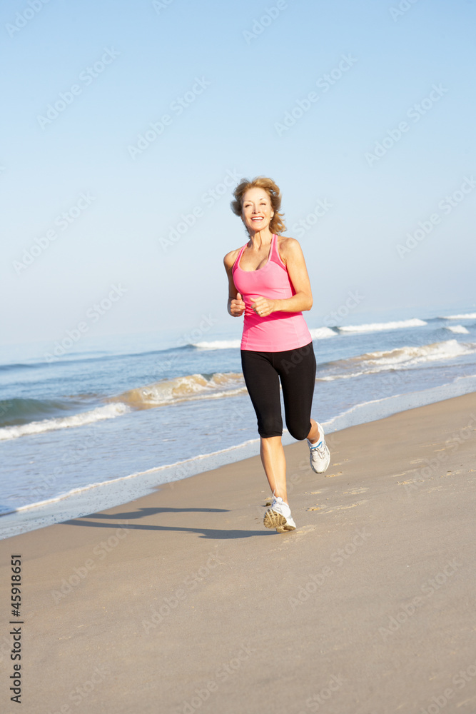 Senior Woman Exercising On Beach