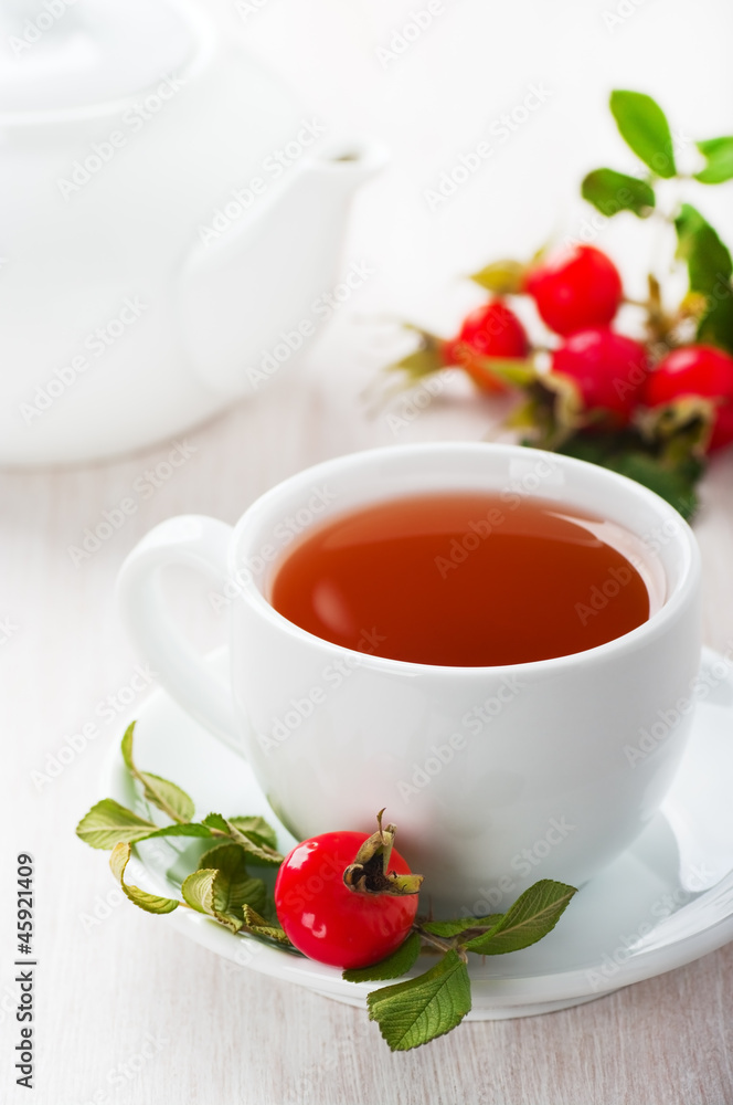 Fresh rose hip and drink a cup of rose hips Fresh rose hip and drink a cup of rose hips