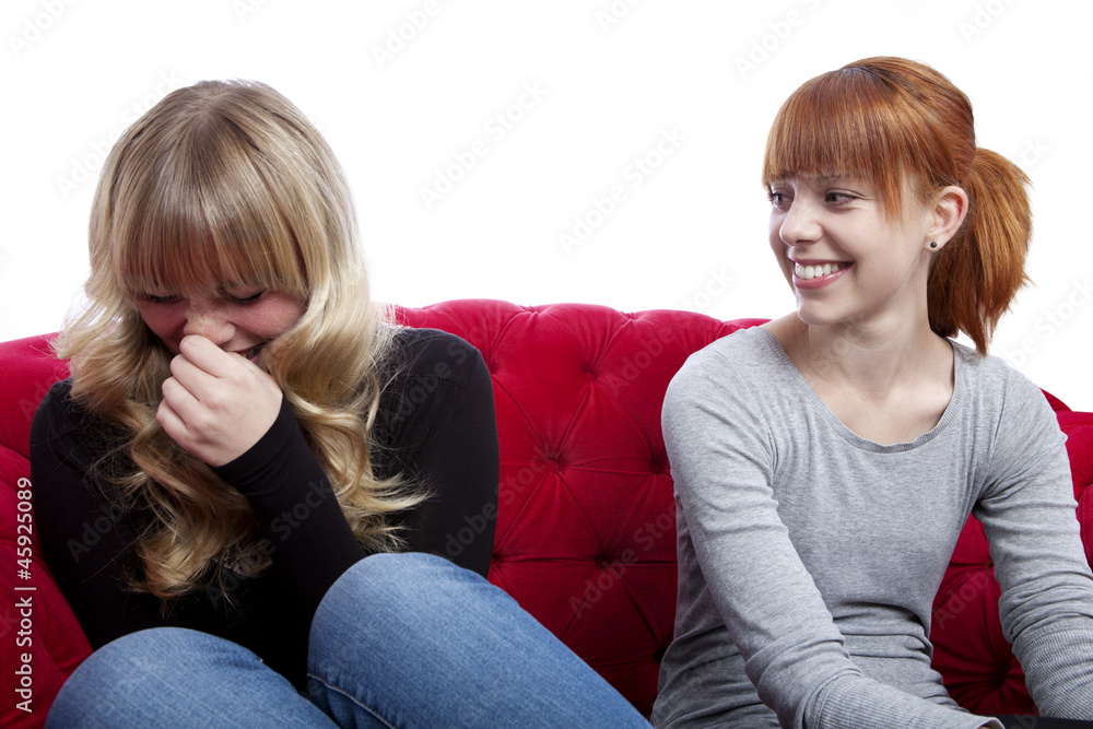 young beautiful blond and red haired girls talking and sitting