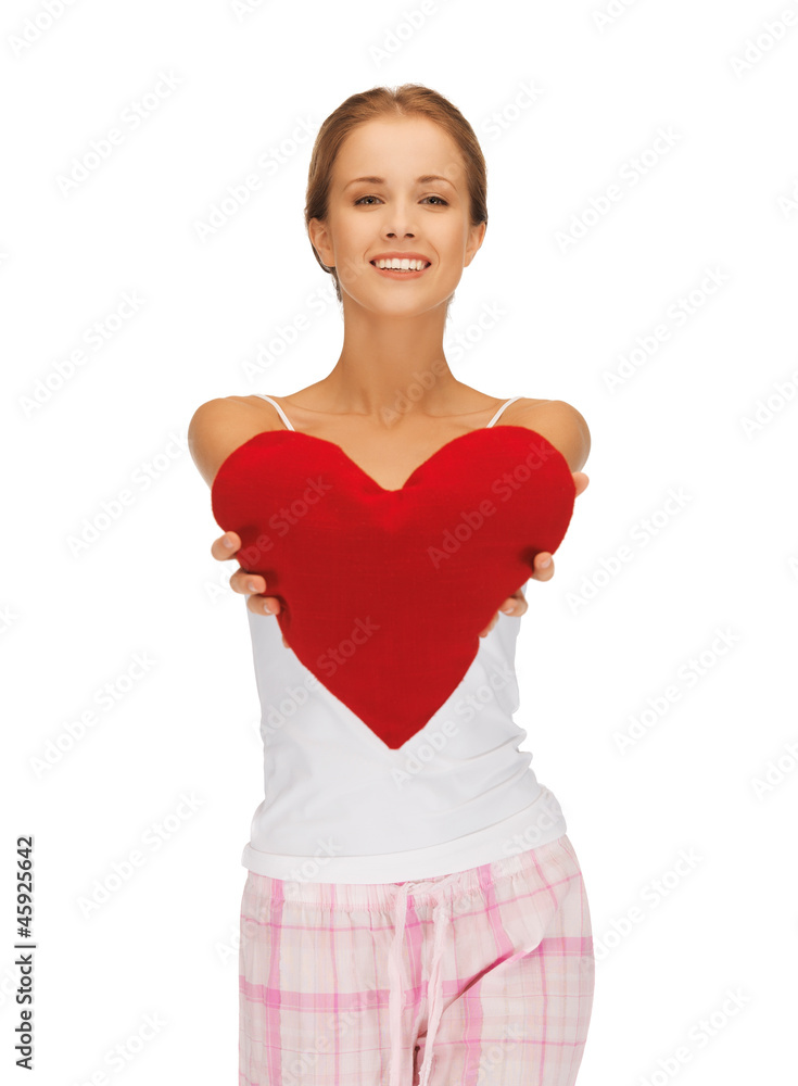 happy and smiling woman with heart-shaped pillow happy and smiling woman with heart-shaped pillow