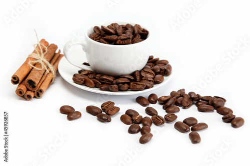 cup with coffee beans isolated on white background.