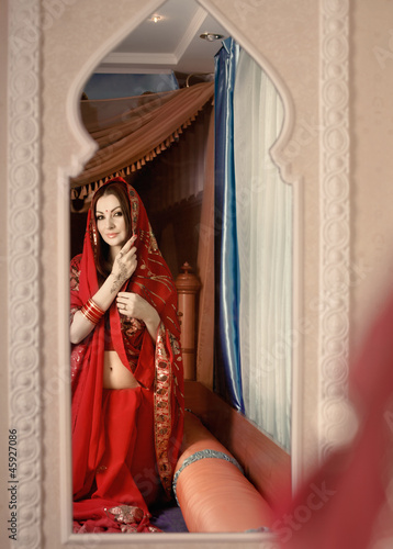 Beautiful Indian bride looking in mirror