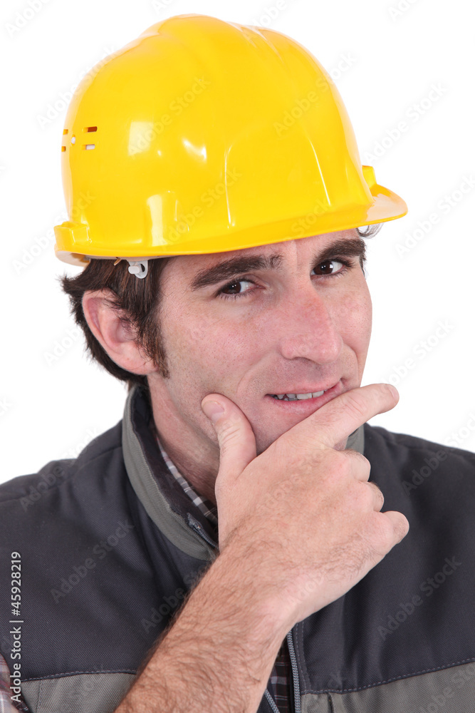 A pensive manual worker. A pensive manual worker.