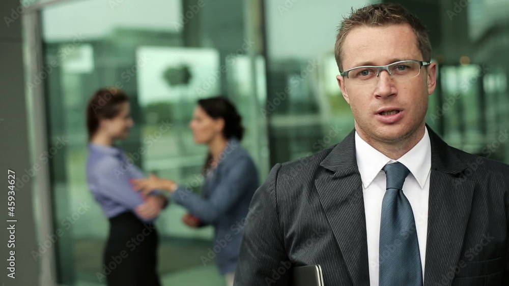 Young businessman talking to camera, steadicam shot Young businessman talking to camera, steadicam shot