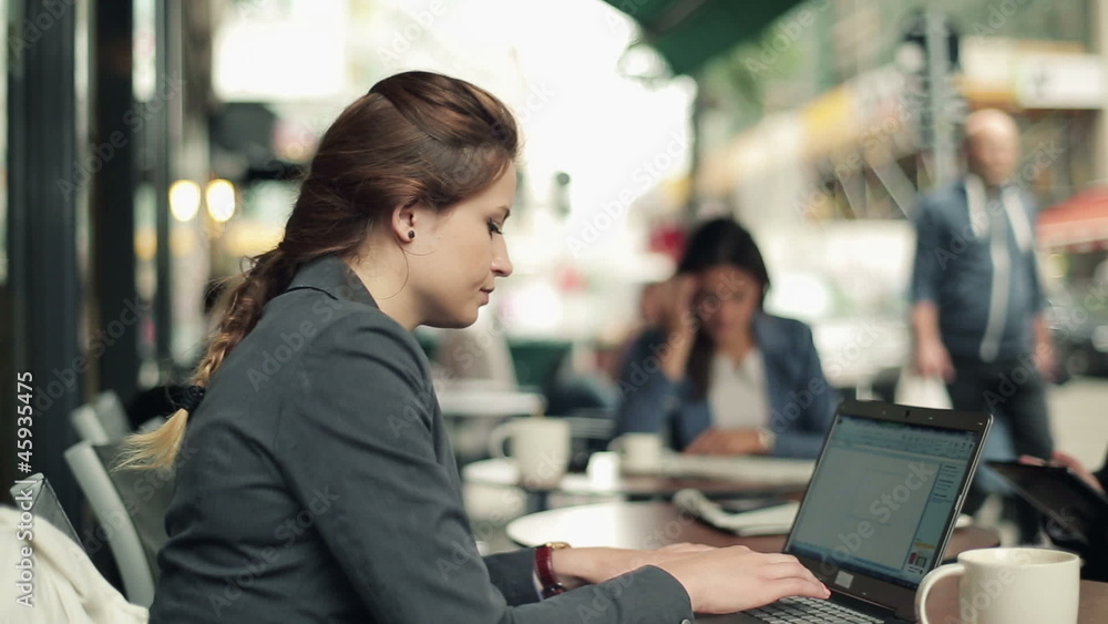 Businesswoman working on laptop and drinking coffee Businesswoman working on laptop and drinking coffee