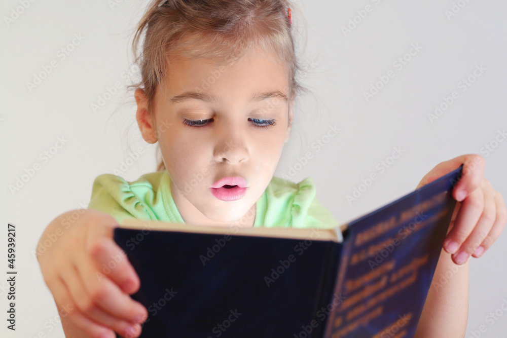 Little blue eyes girl with lighting on face read book Little blue eyes girl with lighting on face read book