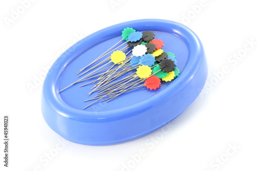 Pin for sewing stick with blue magetic on white background. photo