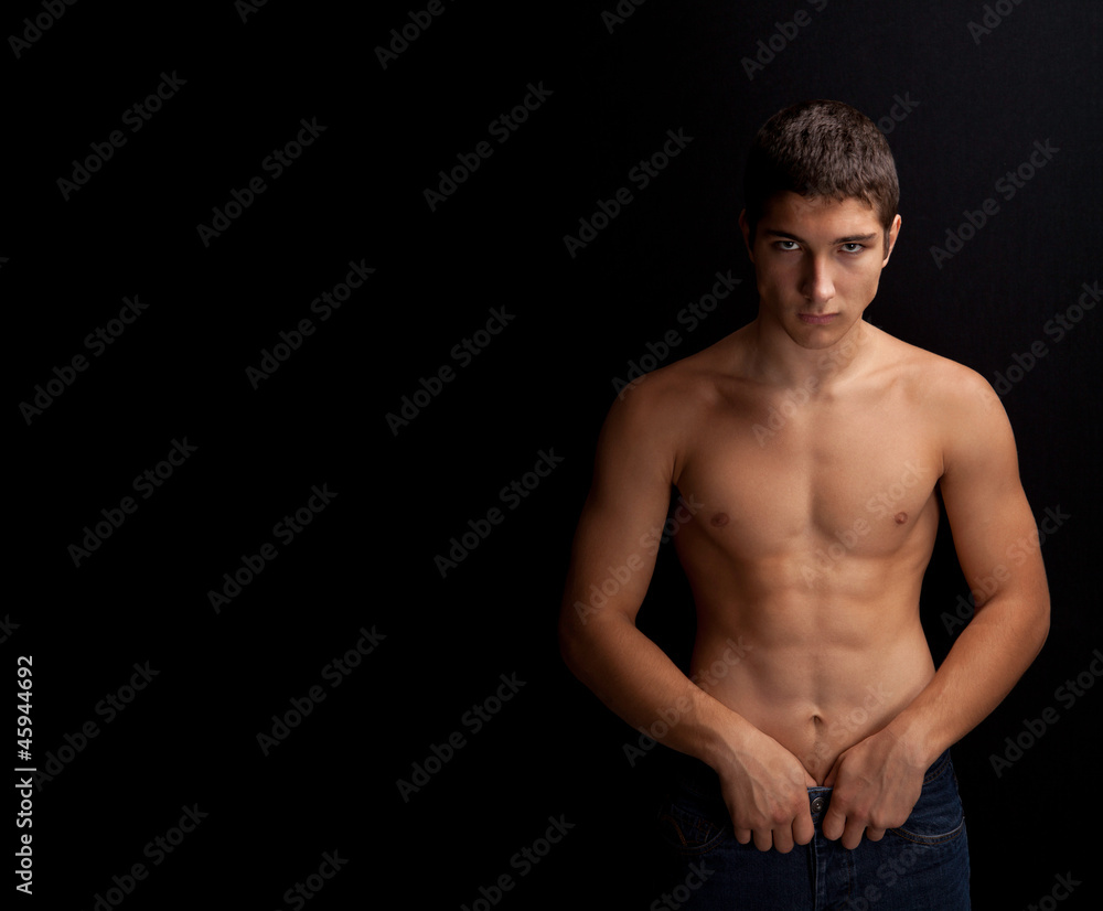 Fototapeta premium young man leaning against a black background