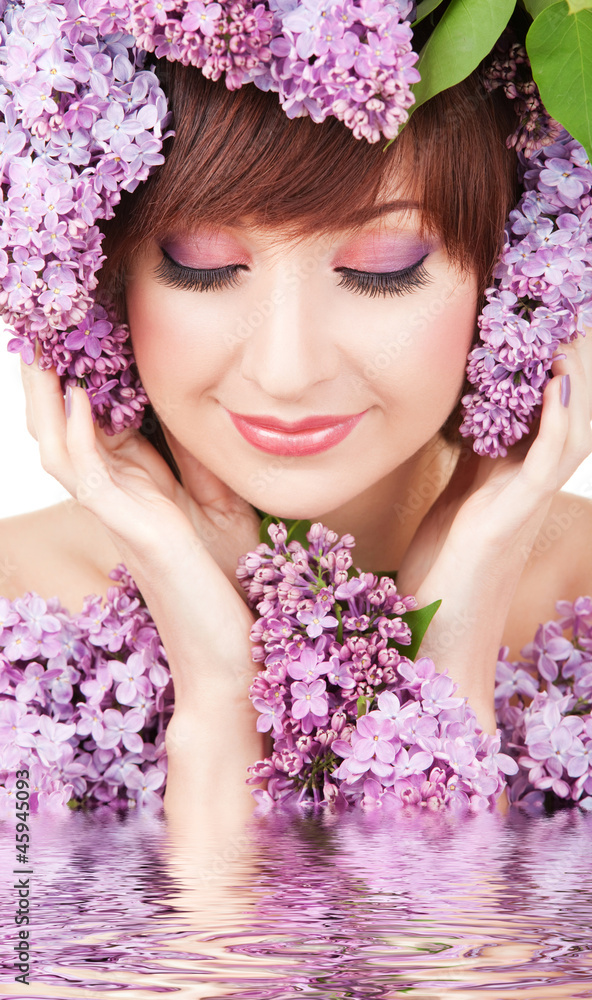 Young woman with lilac flowers in water Young woman with lilac flowers in water