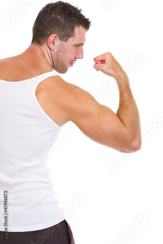 Athletic man showing strong biceps