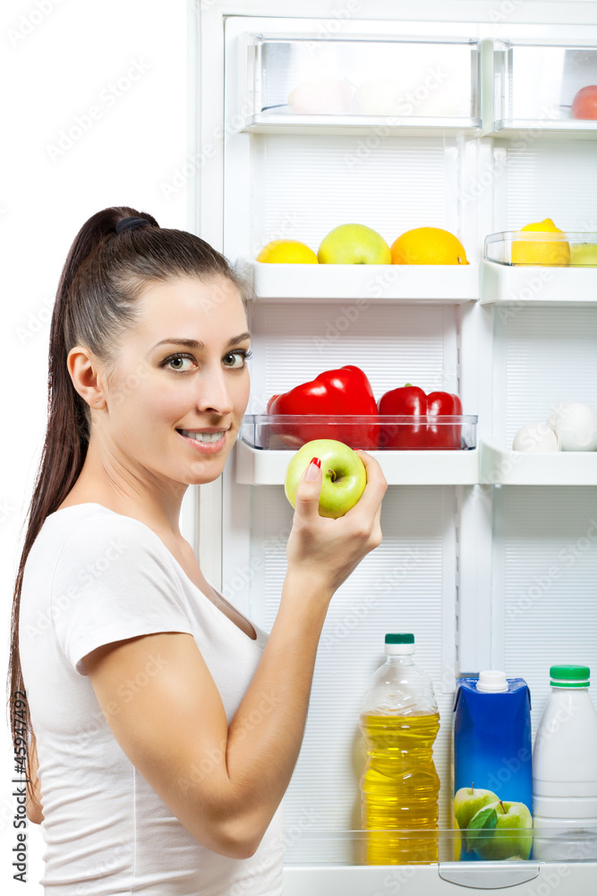 attractive girl near the open refrigerator attractive girl near the open refrigerator
