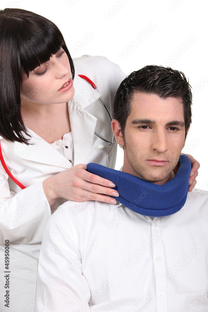 Doctor putting a neck brace on her patient Doctor putting a neck brace on her patient