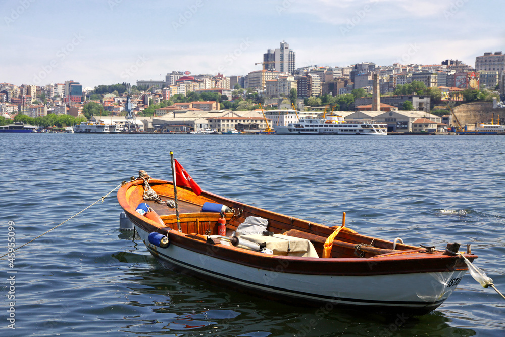 Fishing boat on the Golden Horn Gulf with Istanbul downtown