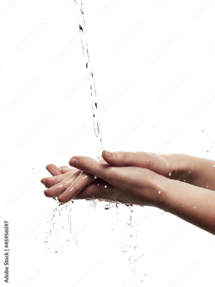 Female hands among splashing water - isolated