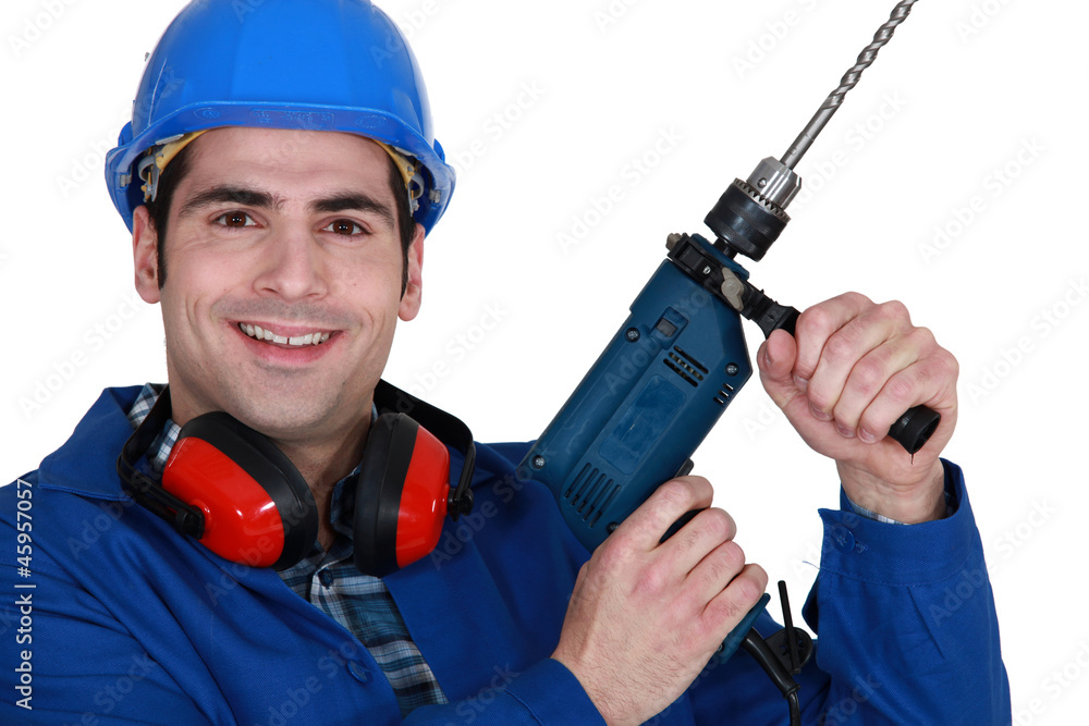 Tradesman holding up an electric screwdriver Tradesman holding up an electric screwdriver