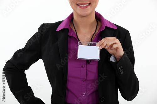 Woman displaying visitor badge photo