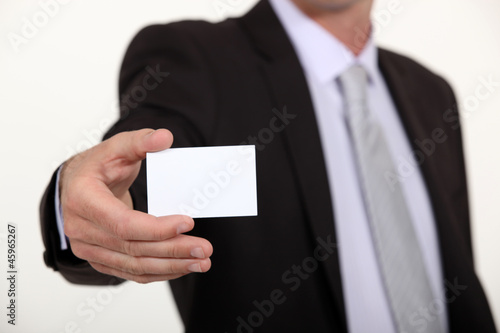 Cropped executive with a blank businesscard