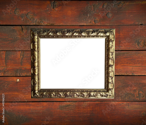 Antique golden frame on wooden wall