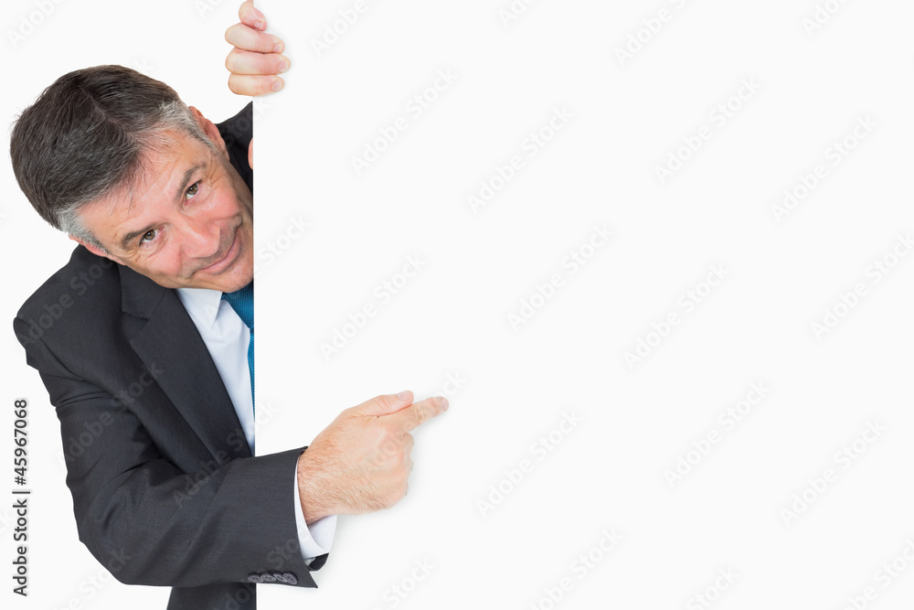 Man pointing to whiteboard and smiling Man pointing to whiteboard and smiling