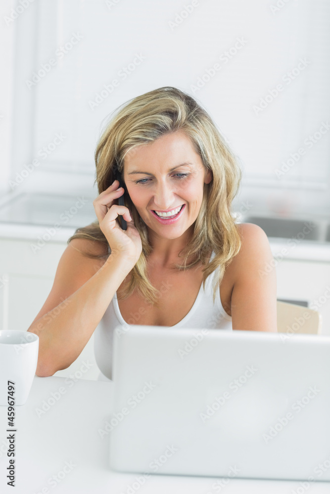 Woman using laptop during call with somebody Woman using laptop during call with somebody