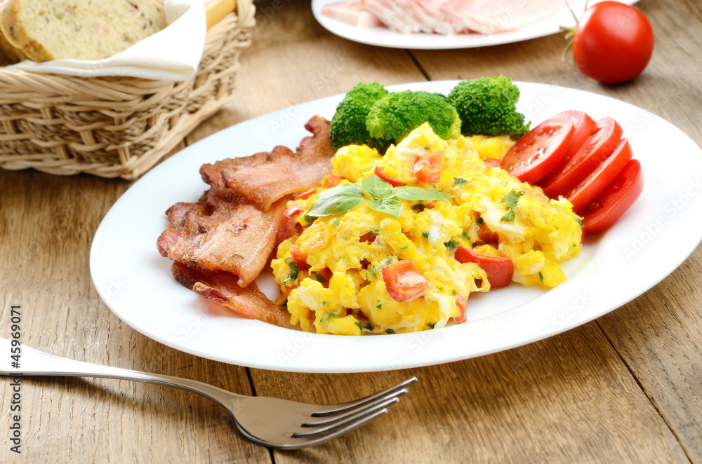 Omelette with vegetables and fried bacon