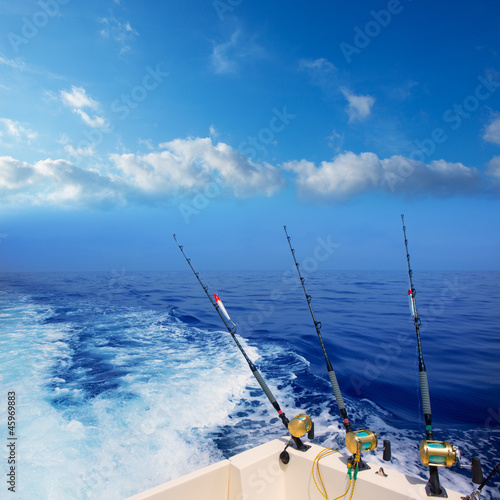 boat fishing trolling in deep blue ocean offshore