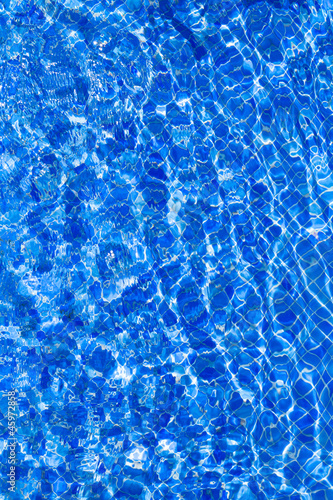 Blue tiels pool with ripple water reflection