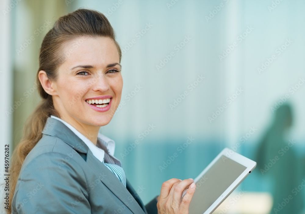 Happy business woman using in tablet PC Happy business woman using in tablet PC