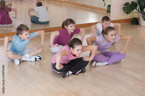 Group of children engaged in physical training indoors.