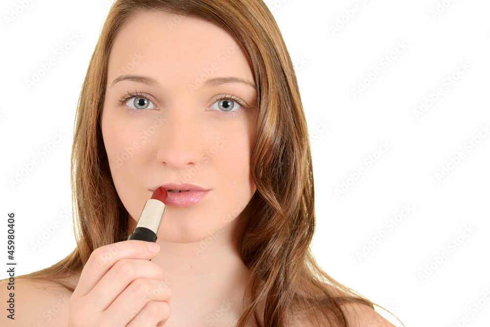 Teen girl putting on red lipstick Teen girl putting on red lipstick