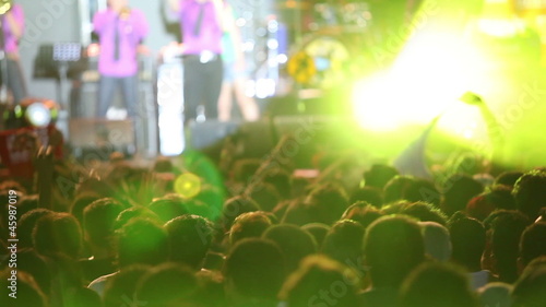 Concert crowd in front of scene with lights
