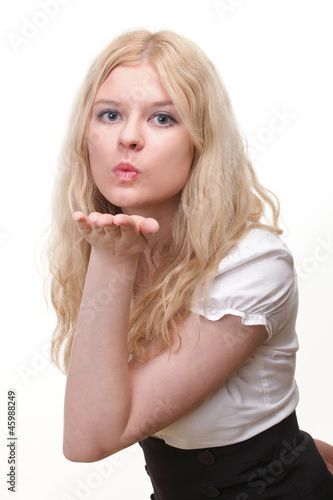 beautiful young woman blowing a kiss