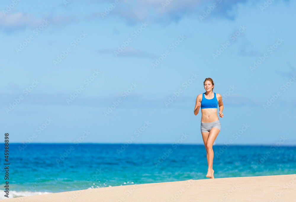 Beautiful Athletic Woman Running on the Beach
