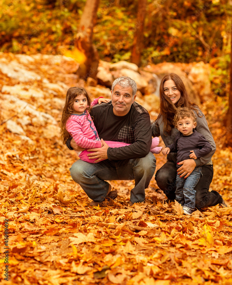Happy family in autumnal forest Happy family in autumnal forest