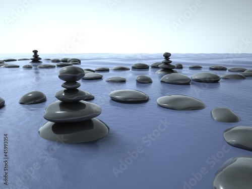 Zen stones in water  blue sky