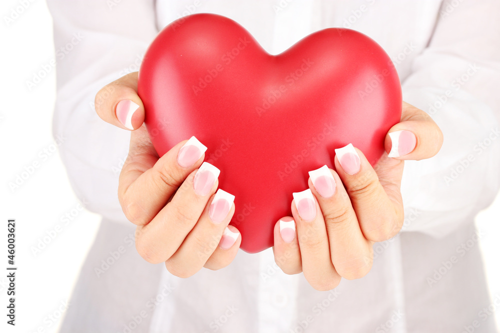 Red heart in woman's hands, on white background close-up Red heart in woman's hands, on white background close-up