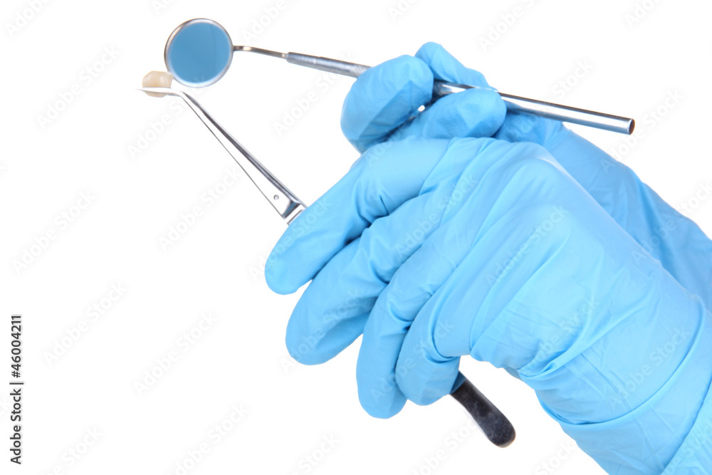 Hands in blue gloves holding dental tools isolated on white Hands in blue gloves holding dental tools isolated on white