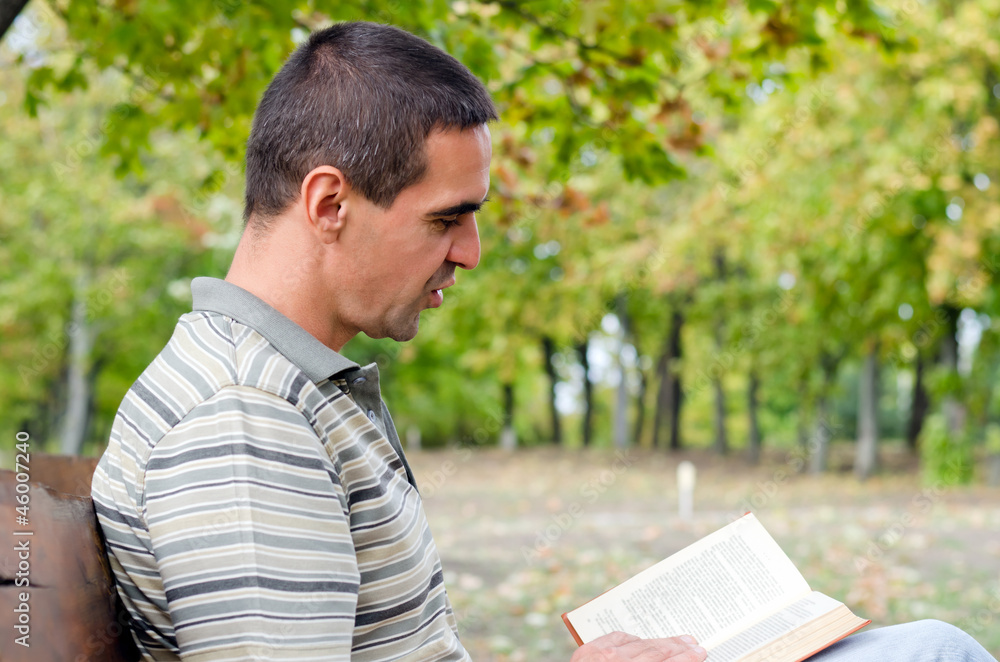 Man enjoying a book outdoors Man enjoying a book outdoors