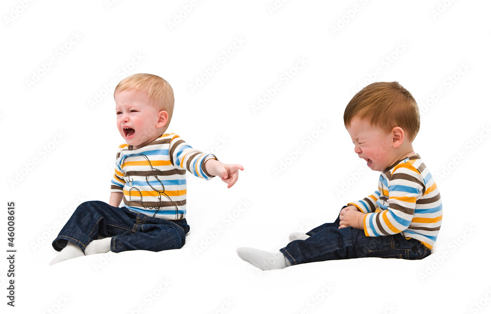 Twins. Both cry, offended each other, sibling, on white Twins. Both cry, offended each other, sibling, on white