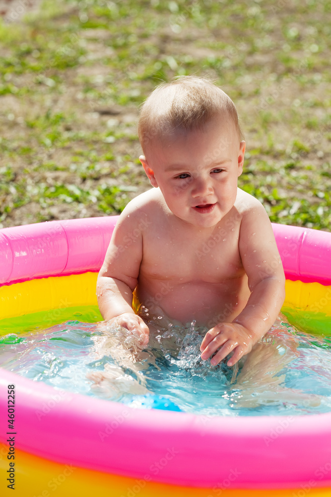 Baby swimming  in kid inflatable pool