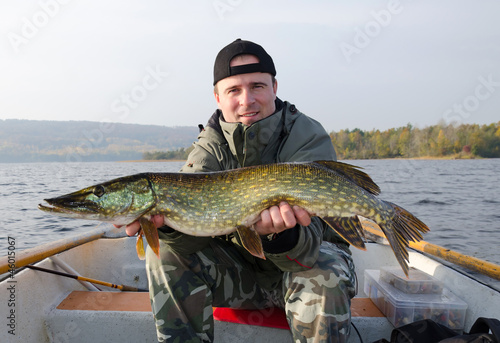 Fototapeta Naklejka Na Ścianę i Meble -  Happy angler with pike fishing trophy