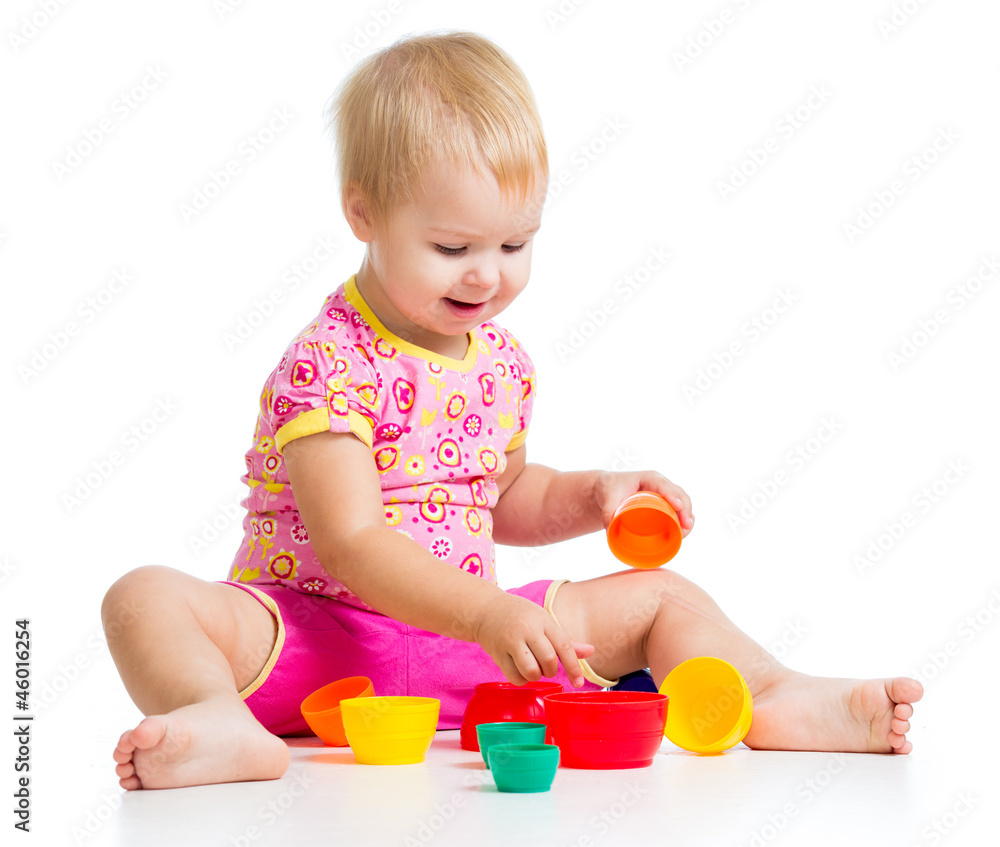 smiling child girl playing with cup toys, isolated over white smiling child girl playing with cup toys, isolated over white