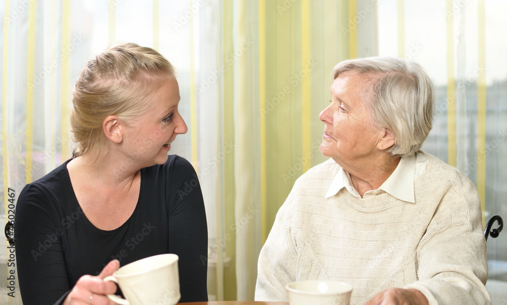 Senior woman with her granddaughter talk to each other.