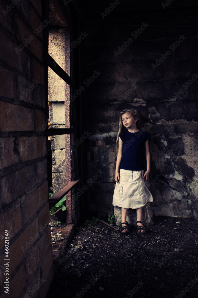 Young girl in grungy building
