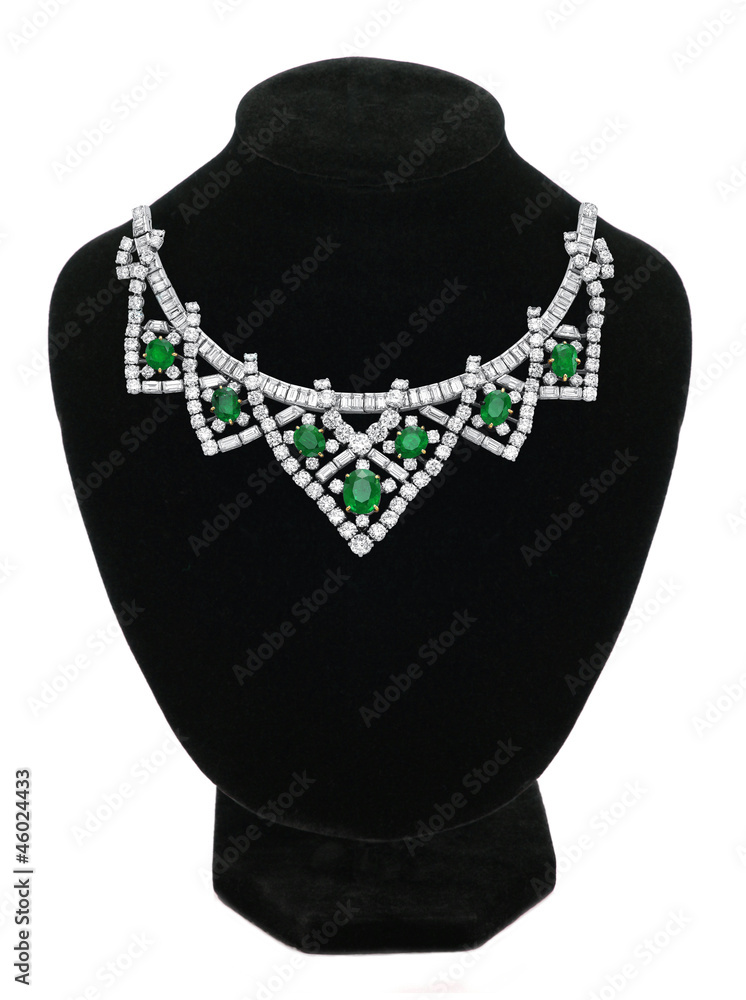 Pendant with green gem stones on black mannequin isolated on whi Pendant with green gem stones on black mannequin isolated on whi