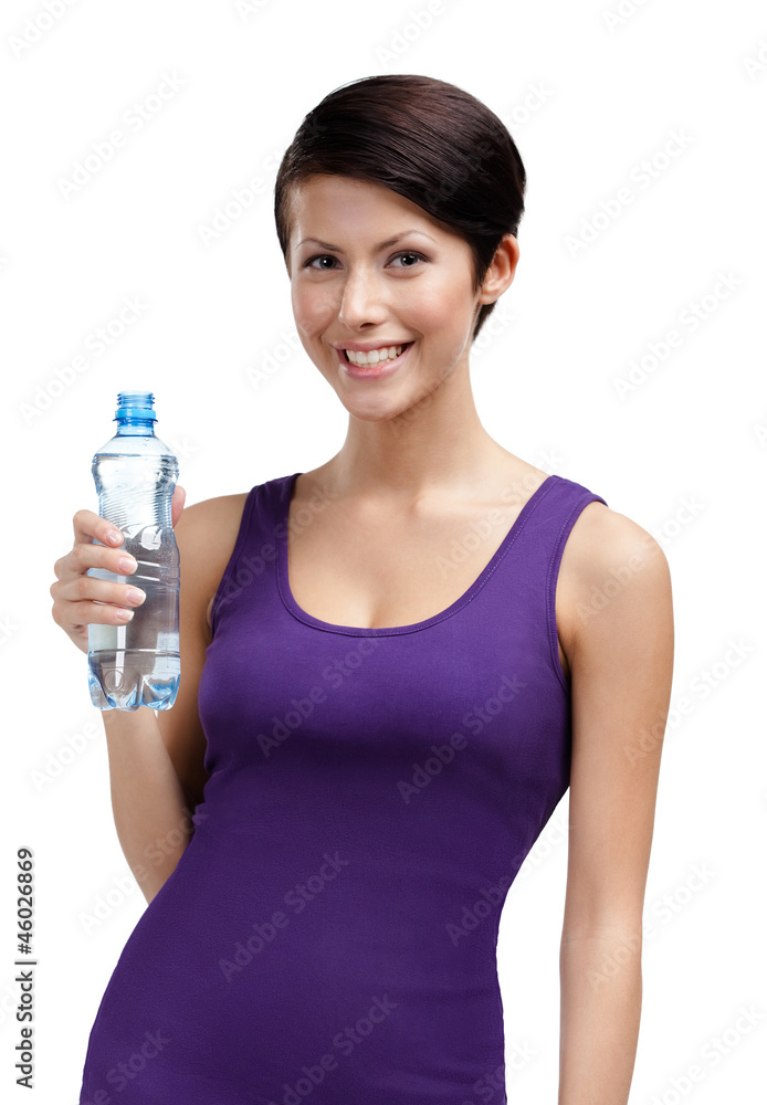 Smiley athletic woman with bottle of mineral water Smiley athletic woman with bottle of mineral water