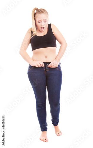 Bild auf Leinwand Size 40 woman zipping tight jeans, overweight concept